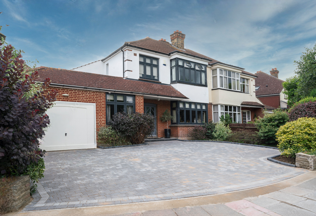 Typical semi-detached house in Lakewood with anthracite grey windows and block paving drive.